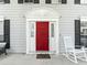 Up close image of the Front Door with a red painted door and white trim at 2619 Green Valley St, Valrico, FL 33596