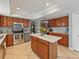 Well-lit kitchen with wood cabinets, a stainless steel oven, and center island at 2619 Green Valley St, Valrico, FL 33596