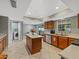 Bright kitchen features wood cabinets, a center island, and stainless steel appliances at 2619 Green Valley St, Valrico, FL 33596