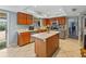 Charming kitchen offers an island, wood cabinets, and stainless steel dishwasher at 2619 Green Valley St, Valrico, FL 33596