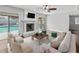 The Living Room, with a fireplace, flows out to the lanai and pool at 2619 Green Valley St, Valrico, FL 33596