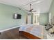View of the main bedroom showing the tv, doorway to bath and ceiling fan at 2619 Green Valley St, Valrico, FL 33596