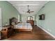 Spacious main bedroom boasts trey ceilings, ceiling fan, and hardwood floors at 2619 Green Valley St, Valrico, FL 33596