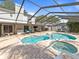 The screened-in pool has a brick paver deck, sun loungers and outdoor furniture at 2619 Green Valley St, Valrico, FL 33596