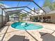 The screened-in pool has a brick paver deck, sun loungers and outdoor furniture at 2619 Green Valley St, Valrico, FL 33596