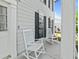Two white rocking chairs sit on the porch at 2619 Green Valley St, Valrico, FL 33596