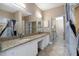 Large bathroom featuring double sinks, granite counters, and a walk in shower at 2705 Via Murano # 127, Clearwater, FL 33764