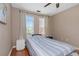 Neutral bedroom with hardwood floors, natural light, and a ceiling fan at 2705 Via Murano # 127, Clearwater, FL 33764