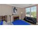 Bedroom featuring a fireplace, futon, and a view of the community landscape at 2705 Via Murano # 127, Clearwater, FL 33764
