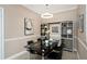 Dining room features a modern light fixture, table with seating for four, and a decorative shelving unit at 2705 Via Murano # 127, Clearwater, FL 33764