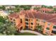 An exterior view of the luxury condo showcasing private balconies and a well-maintained terra cotta roof at 2705 Via Murano # 127, Clearwater, FL 33764