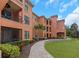 Condo building with mature landscaping, charming walkway, and views of private balconies at 2705 Via Murano # 127, Clearwater, FL 33764