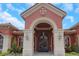 Beautiful front entrance with large arched doorway and decorative iron gate at 2705 Via Murano # 127, Clearwater, FL 33764