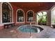Indoor hot tub featuring tile surround, archways and windows for natural light at 2705 Via Murano # 127, Clearwater, FL 33764
