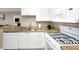 Well-maintained kitchen featuring granite countertops, a gas range, and essential appliances at 2705 Via Murano # 127, Clearwater, FL 33764