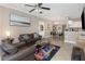 Comfortable living room with ceiling fan, tile floors, and a view of the dining area and kitchen at 2705 Via Murano # 127, Clearwater, FL 33764