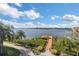 Scenic water view with palm trees, a private dock, and blue sky, ideal for waterfront living at 2705 Via Murano # 127, Clearwater, FL 33764