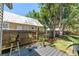 Outdoor deck area with lush greenery and trees in a private fenced backyard, perfect for relaxation at 2911 N Jefferson St, Tampa, FL 33602