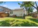 Fenced-in backyard with ample green space and mature trees, providing a serene and private outdoor setting at 2911 N Jefferson St, Tampa, FL 33602