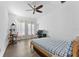 Neutral bedroom featuring light-filled windows, ceiling fan, and a dedicated workspace at 2911 N Jefferson St, Tampa, FL 33602