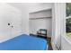 Cozy bedroom with blue quilt, closet, and view to the outdoors through bright, natural light at 2911 N Jefferson St, Tampa, FL 33602