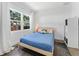 Light-filled bedroom features a large window and a comfortable bed with stylish patterned pillows at 2911 N Jefferson St, Tampa, FL 33602