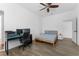 Well-lit bedroom featuring a bed, ceiling fan, and a dedicated workspace at 2911 N Jefferson St, Tampa, FL 33602