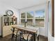 Bright dining area featuring a wooden table, modern black chairs, and natural light from large windows at 2911 N Jefferson St, Tampa, FL 33602