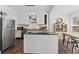 Modern kitchen featuring white cabinets, stainless steel appliances, and an island with seating at 2911 N Jefferson St, Tampa, FL 33602