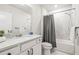 Bright bathroom featuring a shower-tub combo, modern fixtures, and a sleek white vanity at 30273 Marquette Ave, Wesley Chapel, FL 33545