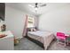 bedroom featuring gray carpet, bed, and pink curtains at 30273 Marquette Ave, Wesley Chapel, FL 33545