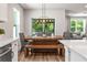 Dining area featuring a rustic wood table, stylish chairs, and abundant natural light at 30273 Marquette Ave, Wesley Chapel, FL 33545