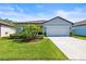 Charming single-story home with a well-manicured lawn, complemented by mature landscaping and a two-car garage at 30273 Marquette Ave, Wesley Chapel, FL 33545