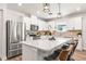 Modern kitchen boasts stainless steel appliances, a large center island, and quartz countertops at 30273 Marquette Ave, Wesley Chapel, FL 33545