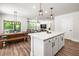 Spacious kitchen with a large island, stainless appliances, and open flow to the dining and living areas at 30273 Marquette Ave, Wesley Chapel, FL 33545