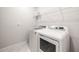 Laundry room with white washer and dryer at 30273 Marquette Ave, Wesley Chapel, FL 33545