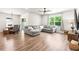 Comfortable living room with a sectional sofa, and large windows offering serene outdoor views at 30273 Marquette Ave, Wesley Chapel, FL 33545
