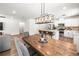 Open-concept space with stainless steel appliances, quartz countertops, and a seamless transition to the living room at 30273 Marquette Ave, Wesley Chapel, FL 33545