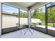 Screened in patio with table and chairs at 30273 Marquette Ave, Wesley Chapel, FL 33545