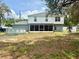 Expansive backyard featuring a two-story home with a screened-in porch and above-ground pool at 3181 Deltona Blvd, Spring Hill, FL 34606