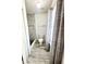 Bathroom featuring a toilet, gray tile flooring, and an updated shower with white marble tile at 3181 Deltona Blvd, Spring Hill, FL 34606