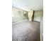 Spacious bedroom with neutral walls and carpet, arched wall niches, and light fixture at 3181 Deltona Blvd, Spring Hill, FL 34606