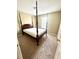 Bedroom showcasing a four-poster bed with a view of the window and a closet at 3181 Deltona Blvd, Spring Hill, FL 34606