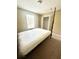 Bedroom showcasing a four-poster bed with a view of the window and a closet at 3181 Deltona Blvd, Spring Hill, FL 34606
