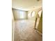 Spacious bedroom with neutral walls and carpet, arched wall niches, and natural light from a window at 3181 Deltona Blvd, Spring Hill, FL 34606