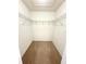 Spacious walk-in closet featuring ample shelving and carpeted flooring at 3181 Deltona Blvd, Spring Hill, FL 34606