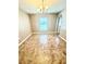 Dining area featuring neutral walls, tile floors, and a modern chandelier at 3181 Deltona Blvd, Spring Hill, FL 34606