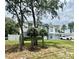 Inviting two-story home featuring an attached two car garage and manicured yard at 3181 Deltona Blvd, Spring Hill, FL 34606
