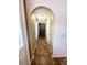 Hallway with decorative archways and tiled floors leading to other rooms at 3181 Deltona Blvd, Spring Hill, FL 34606