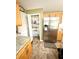 A stainless refrigerator and open pantry enhance the features of this kitchen at 3181 Deltona Blvd, Spring Hill, FL 34606